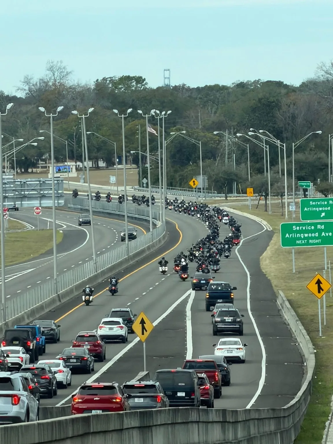 A large motorcycle convoy during a local group ride, showing the wider riding community, not exclusively UNWORTHY MC members.